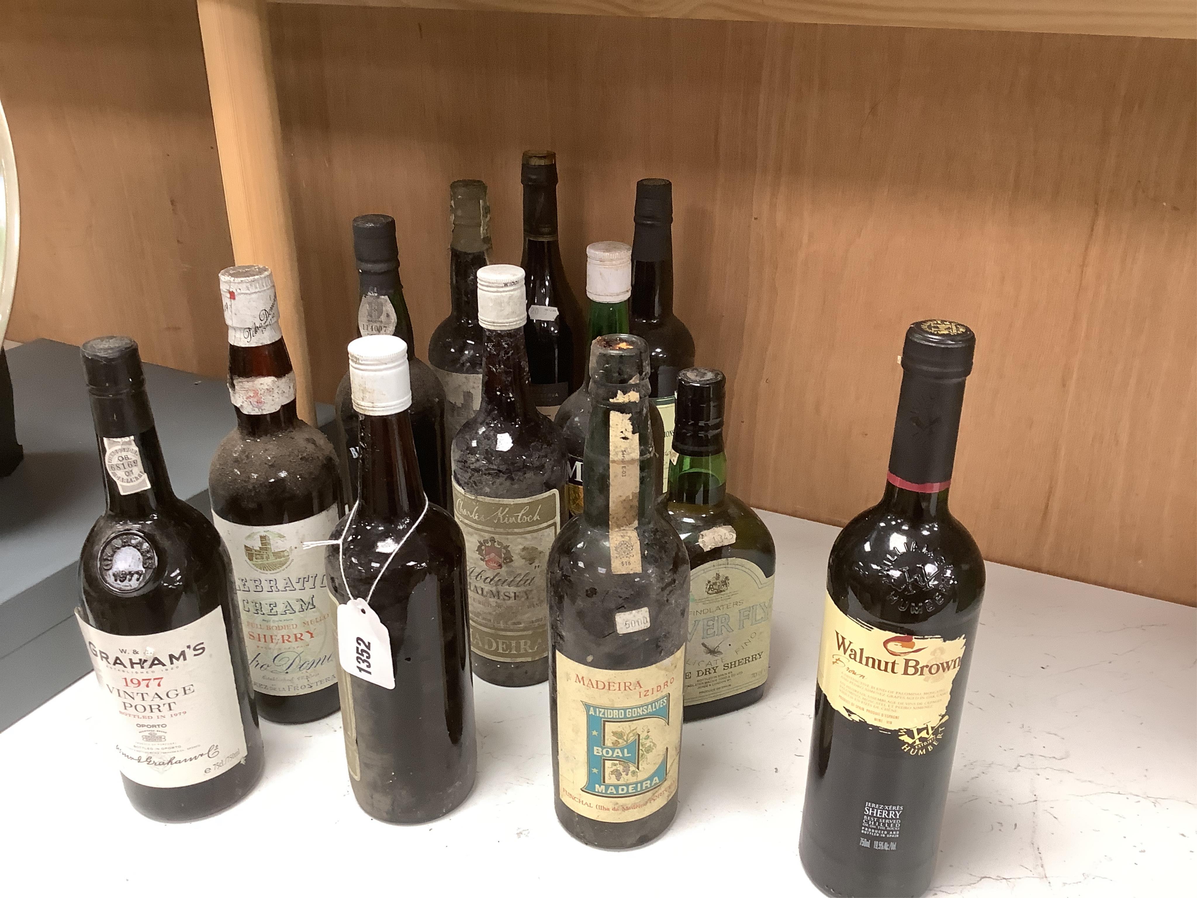 Twelve bottles of various Ports, Madeiras and Sherry, including a bottle of Graham’s vintage Port 1977. Condition - storage unknown